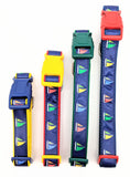 Four sailboat dog collars shown vertically with different colors of nylon webbing and plastic buckles. All collars are navy blue ribbon with sailboat designs in red, yellow, green, and blue. Plastic buckles in red, green, yellow, and navy blue are shown.