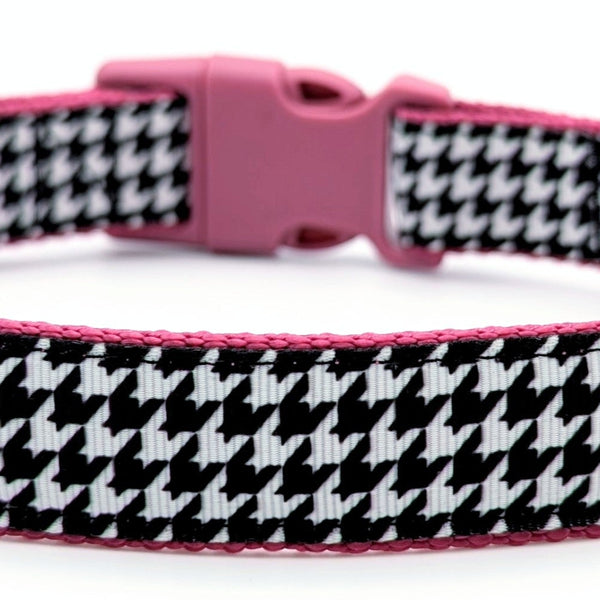 black and white houndstooth design dog collar with raspberry pink nylon under the ribbon and a raspberry pink plastic buckle