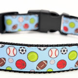 All-Star Sports Ball dog collar featuring baseball, basketball, football, soccer, tennis, and volleyball on a light blue ribbon with a black plastic buckle.