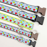 A lineup of multiple All-Star Sports Ball dog collars showing the light blue multi-sport ribbon on different colored nylon webbing bases.