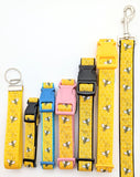Bumblebee ribbon dog collars shown across XS to Large sizes with assorted webbing backing colors and with a key fob and leash