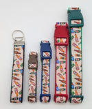Set of dog collars and keychains with beer bottle pattern on a white background