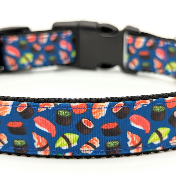 Dog collar with blue background with various pieces of colorful sushi.