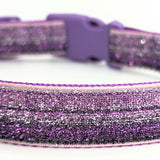 purple ombre sparkle dog collar that fades from purple to silver sparkles. Collar is made with a purple nylon backing and a purple buckle. All on a plain white background.