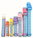 A collection of Spring Bunny Floral dog collars in various widths from 5/8 inch to 1 inch, showing the rabbit pattern scale.