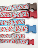 Group of Winter Cardinal dog collars in various widths, including 5/8 inch and 1 inch sizes, showing the cardinal bird pattern scale.