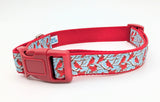 Handmade Winter Cardinal dog collar featuring red birds on snowy branches ribbon against a light blue nylon background.
