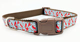 Handmade Winter Cardinal dog collar featuring red birds on snowy branches ribbon against a light blue nylon background.
