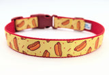 Medium dog collar featuring illustrated hotdogs and red details on sunny yellow ribbon with sturdy webbing backing