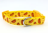 Small dog collar with yellow novelty hotdog ribbon and red accents, black side-release buckle, and metal D-ring