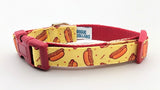 Extra small dog collar with bright yellow ribbon featuring cartoon hotdogs and red accents sewn onto durable webbing